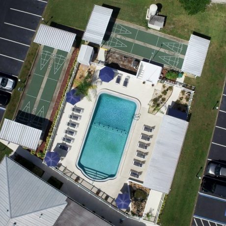 aerial view of pool and shuffleboard court